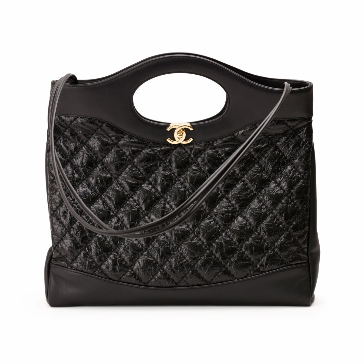 Black quilted leather Chanel handbag with gold CC logo, curated Pre-loved Luxury by Myluxe in Helsinki.