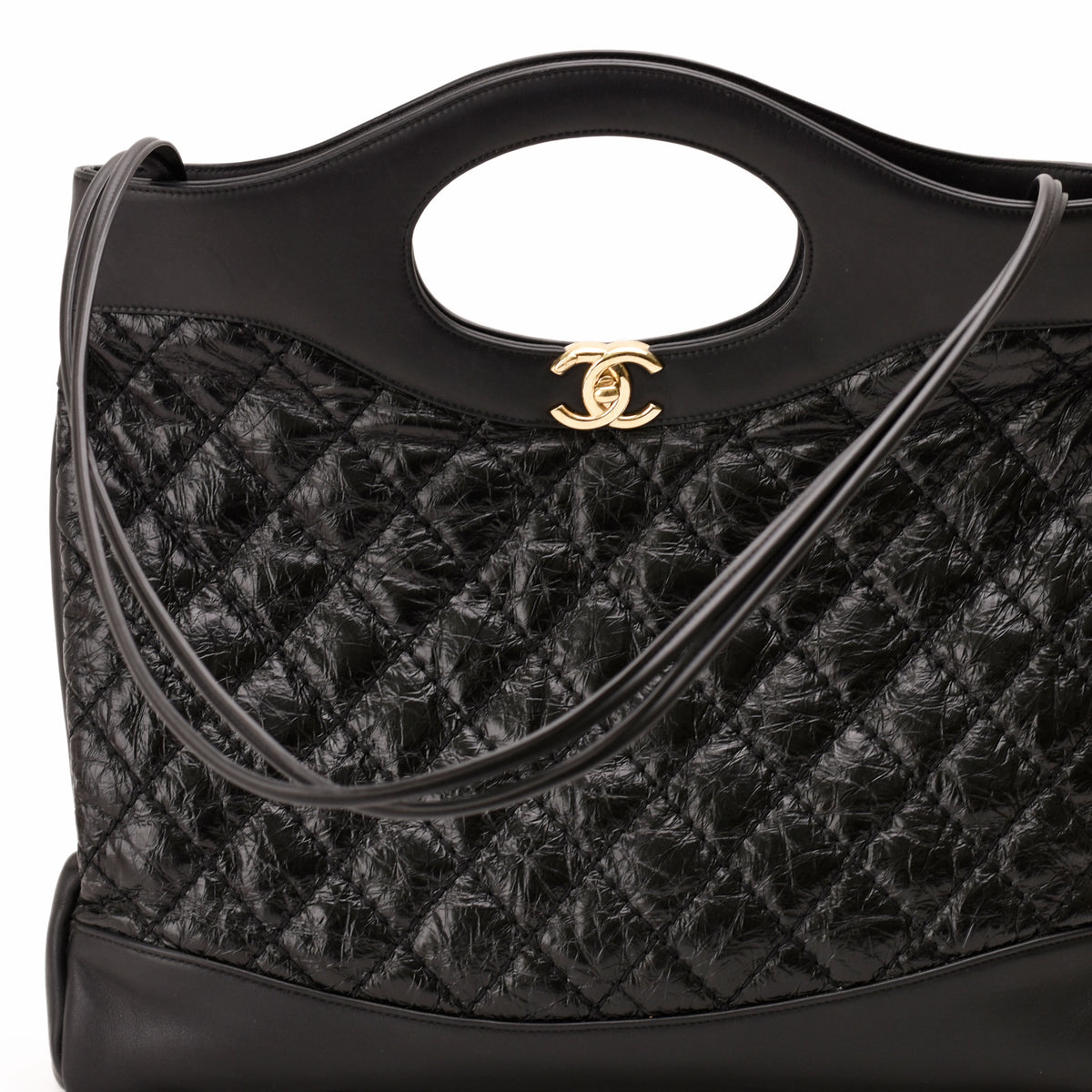 Black quilted nylon Chanel tote bag with gold-tone CC logo, curated Pre-loved Luxury by Myluxe in Helsinki.