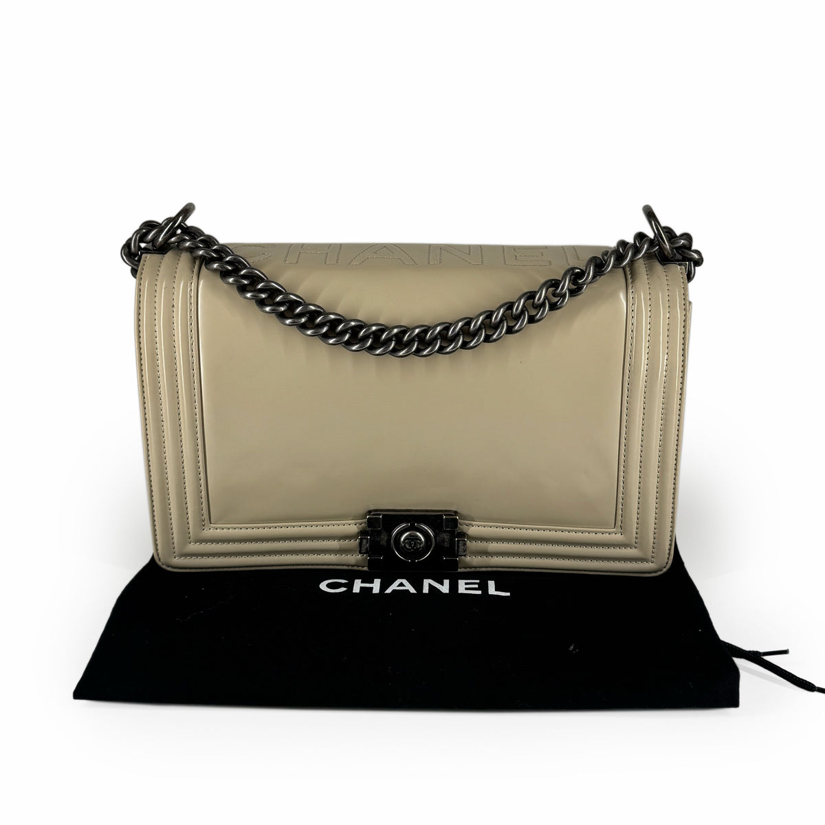 Beige leather Chanel flap bag with dark gunmetal chain strap, curated Pre-loved Luxury by Myluxe in Helsinki.