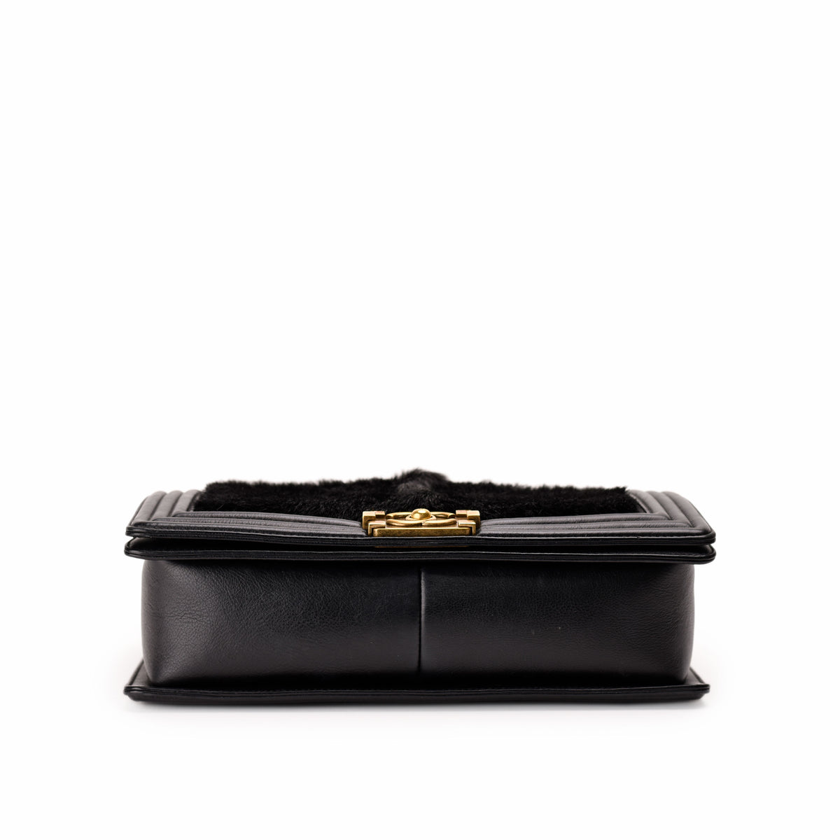 Black leather clutch bag with black faux fur trim and gold-tone clasp, curated Pre-loved Luxury by Myluxe in Helsinki.