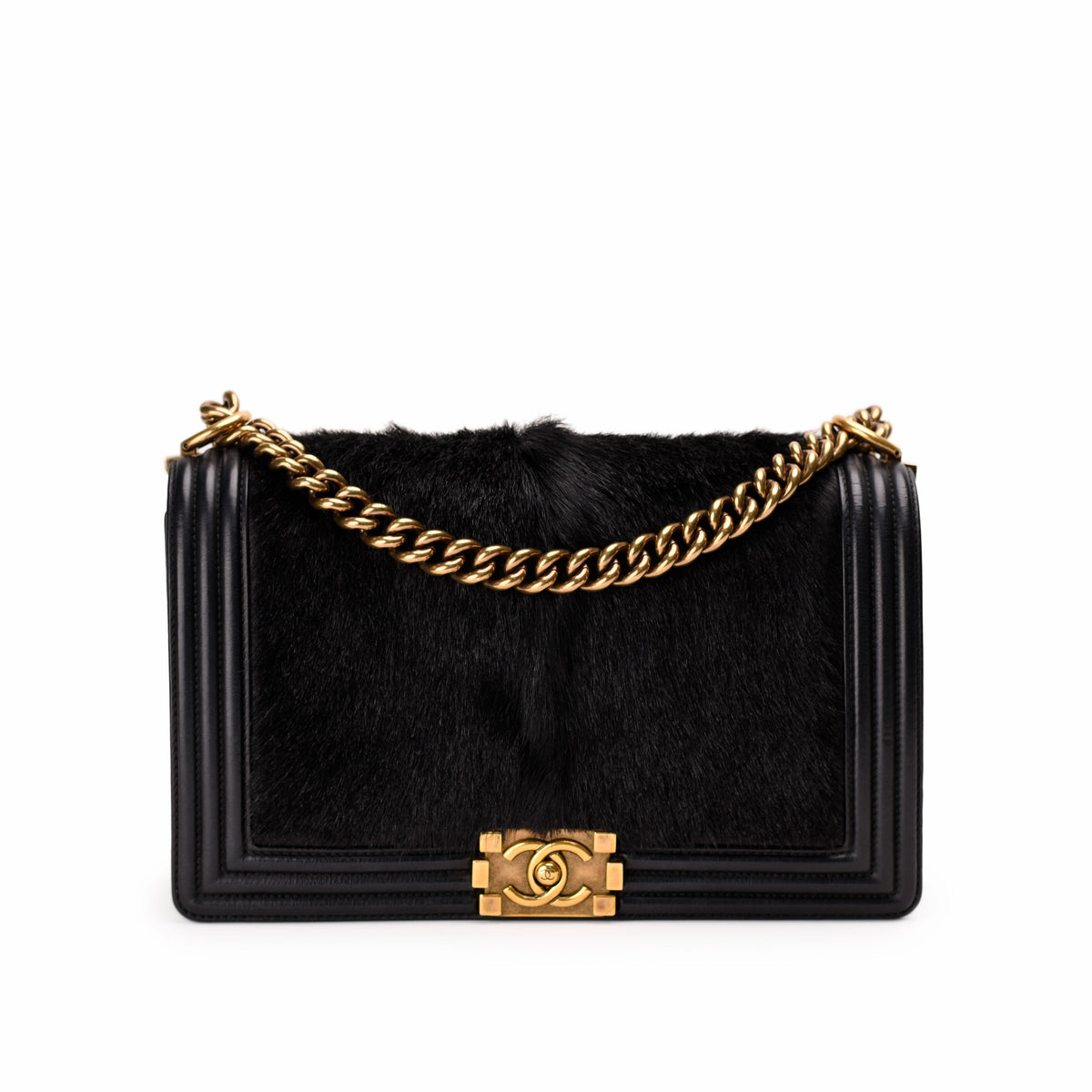 Black faux fur Chanel flap bag with gold-tone chain strap, curated Pre-loved Luxury by Myluxe in Helsinki.