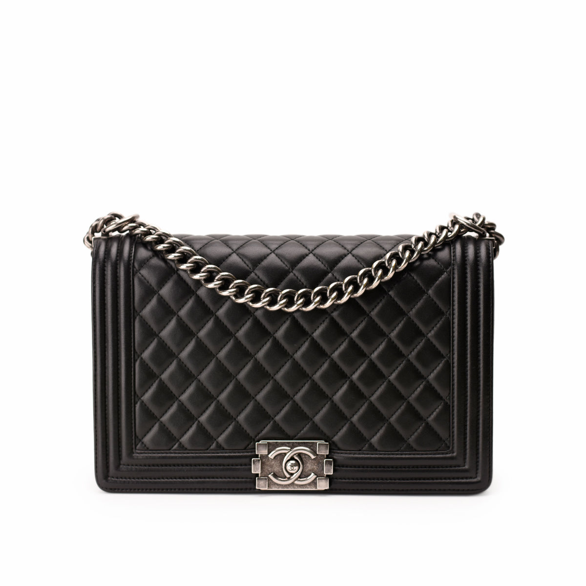 Black quilted leather Chanel flap bag with silver chain strap, curated Pre-loved Luxury by Myluxe in Helsinki.