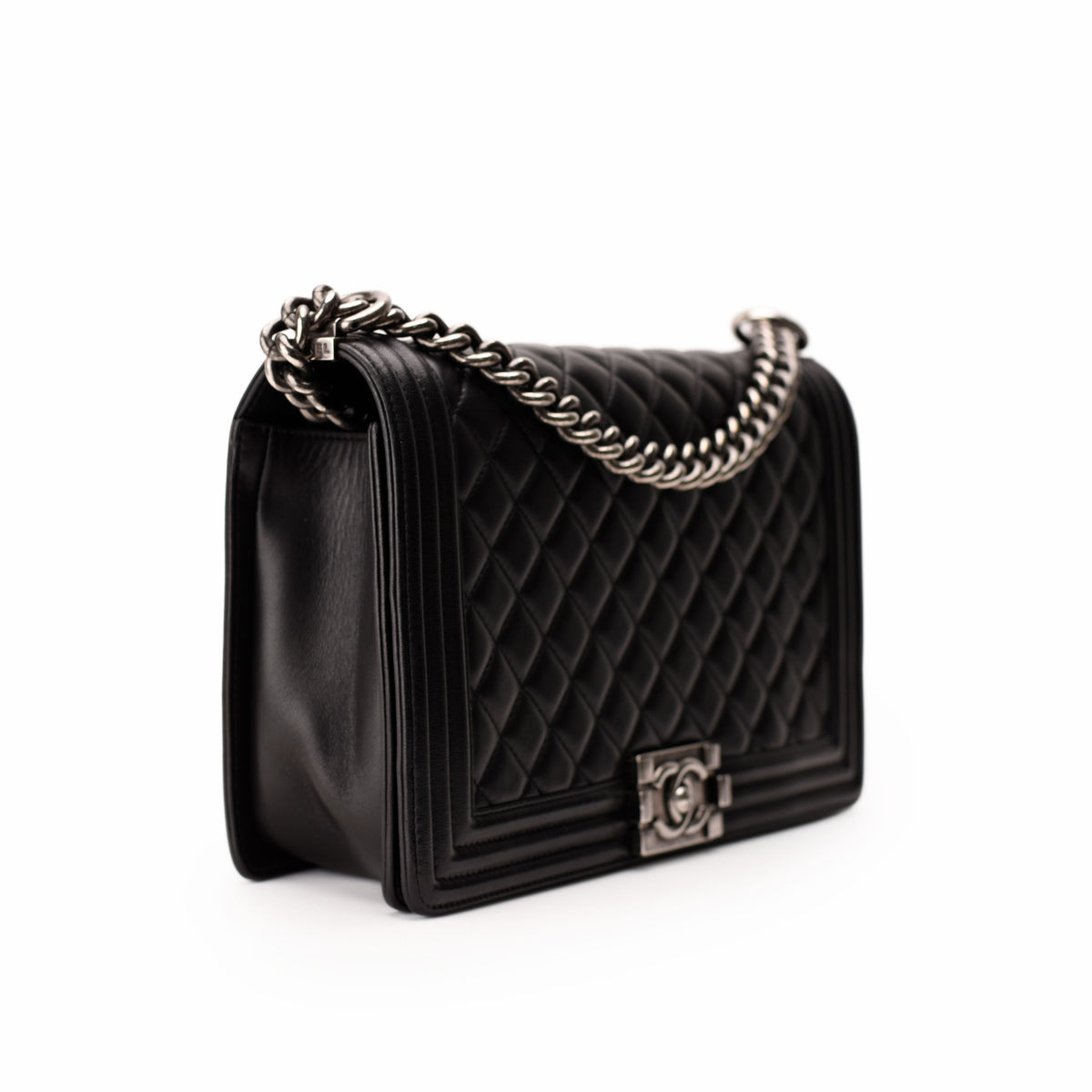 Black quilted leather Chanel handbag with silver chain strap, curated Pre-loved Luxury by Myluxe in Helsinki.
