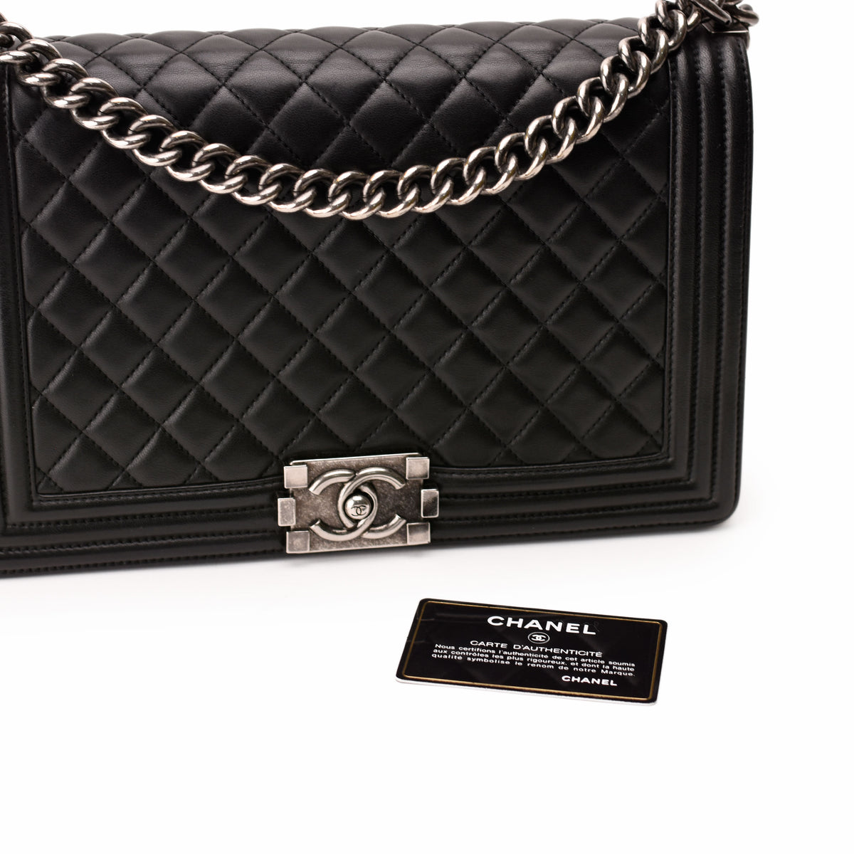 Black quilted lambskin Chanel Boy bag with silver-tone chain strap, curated Pre-loved Luxury by Myluxe in Helsinki.