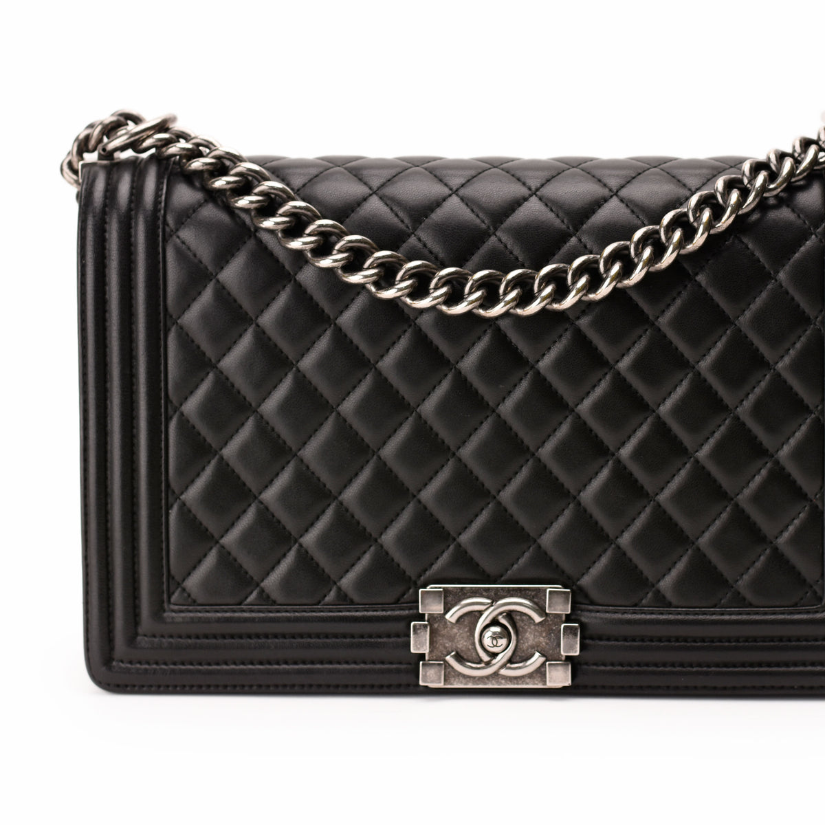 Black quilted leather Chanel flap bag with silver chain strap, curated Pre-loved Luxury by Myluxe in Helsinki.