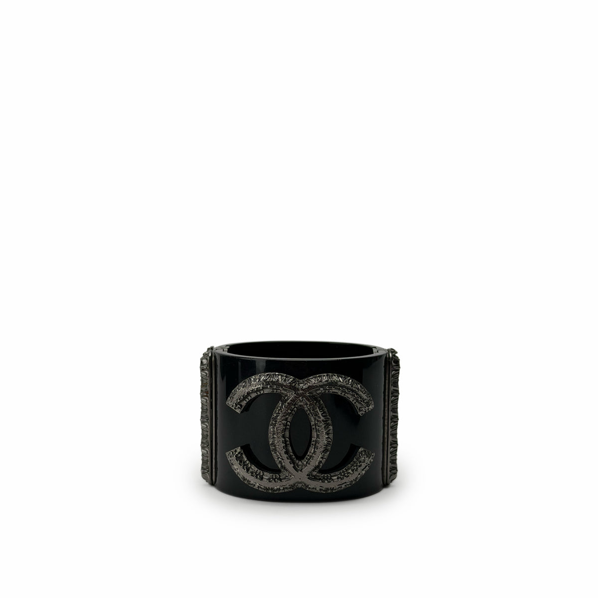 Black Chanel cuff bracelet featuring a silver-tone interlocking CC logo, curated Pre-loved Luxury by Myluxe in Helsinki.