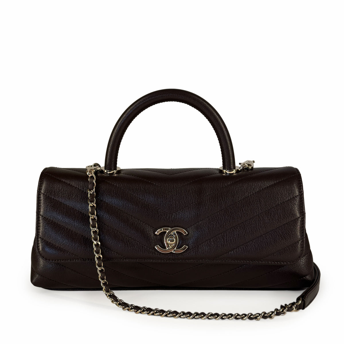 Dark brown quilted leather Chanel handbag with silver hardware, curated Pre-loved Luxury by Myluxe in Helsinki.