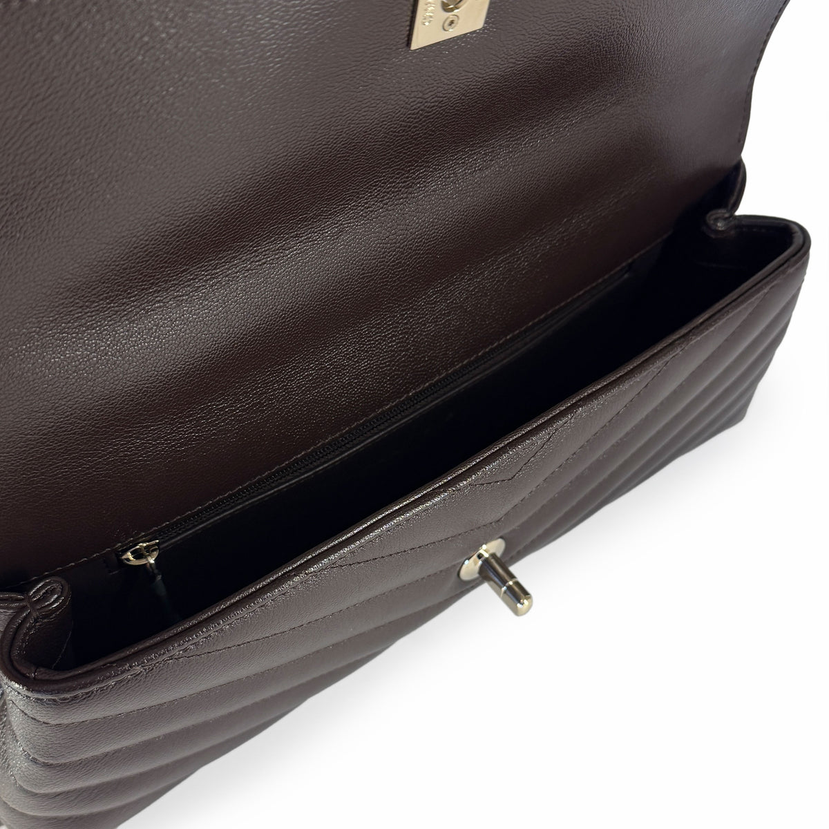 Open dark brown quilted leather handbag showing interior, curated Pre-loved Luxury by Myluxe in Helsinki.