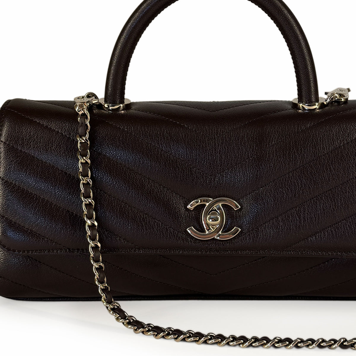 Dark brown quilted leather Chanel handbag with silver hardware, curated Pre-loved Luxury by Myluxe in Helsinki.