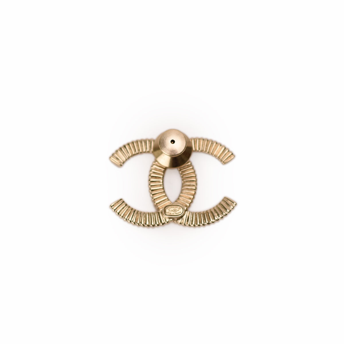 Gold-tone Chanel interlocking CC logo jewelry piece. Curated Pre-loved Luxury by Myluxe in Helsinki.