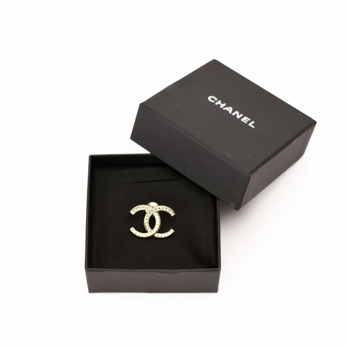 Gold-tone Chanel interlocking CC logo brooch encrusted with crystals. curated Pre-loved Luxury by Myluxe in Helsinki.