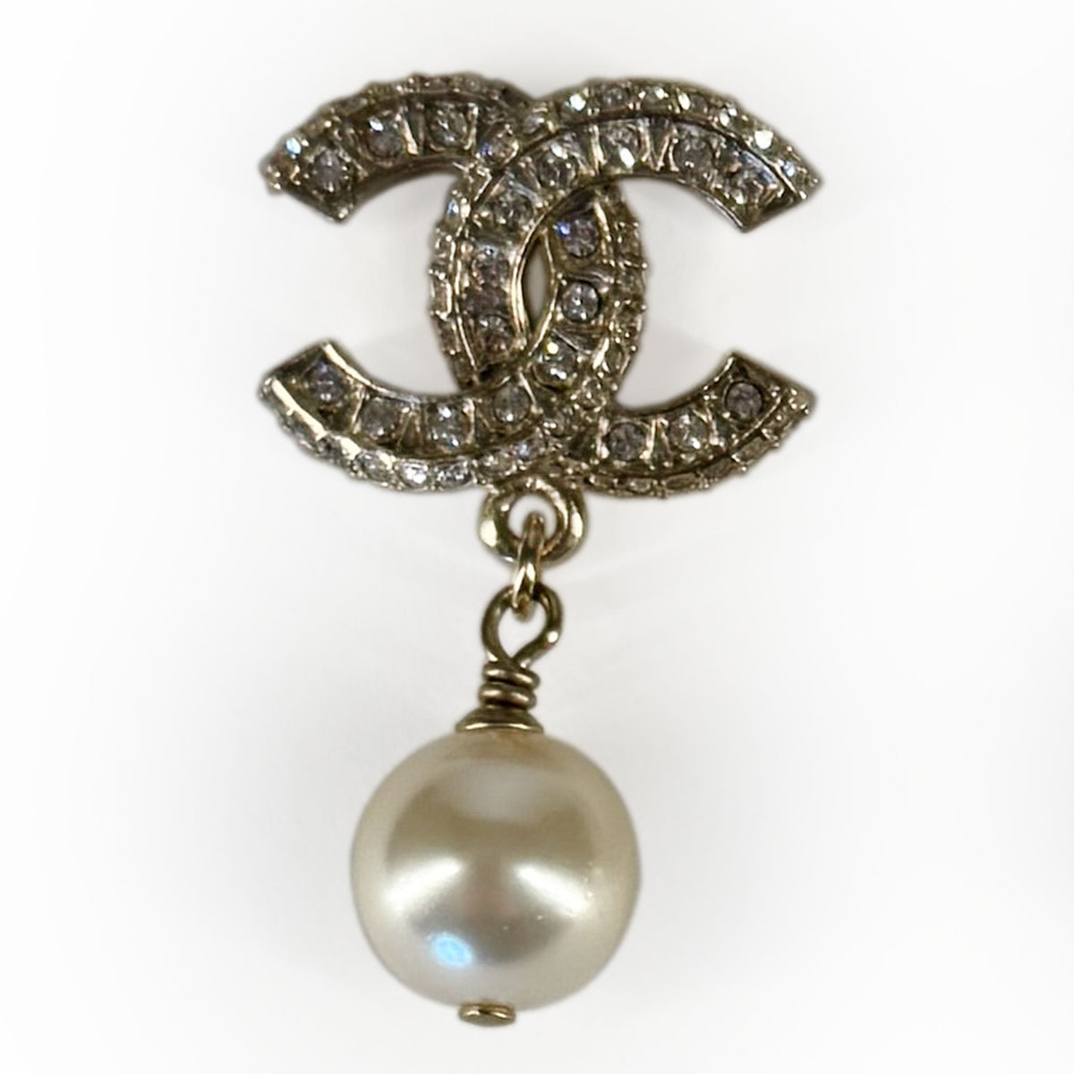 Chanel interlocking CC logo brooch with clear crystals and a large cream pearl, curated Pre-loved Luxury by Myluxe in Helsinki.