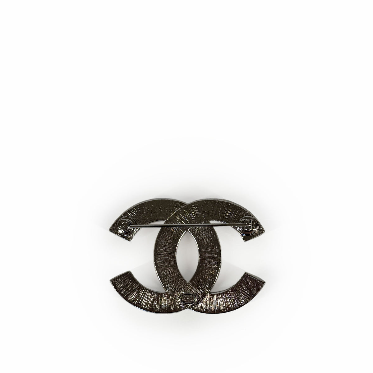 Chanel interlocking CC logo silver-tone metal brooch, curated Pre-loved Luxury by Myluxe in Helsinki.