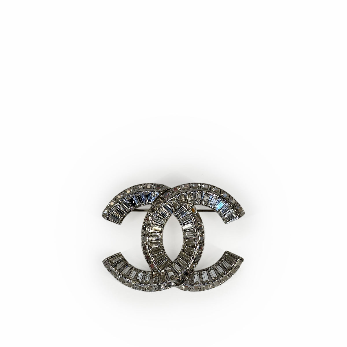 Silver-tone Chanel interlocking CC brooch encrusted with baguette crystals, curated Pre-loved Luxury by Myluxe in Helsinki.