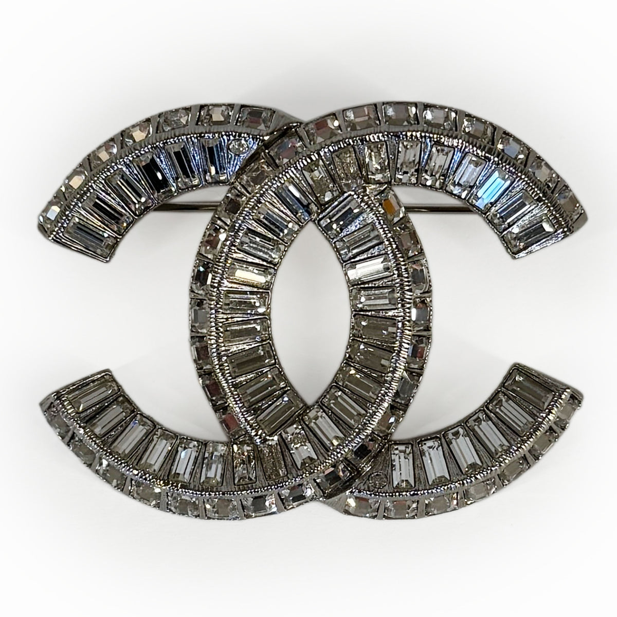 Silver-tone Chanel interlocking CC brooch encrusted with baguette and round crystals, curated Pre-loved Luxury by Myluxe in Helsinki.