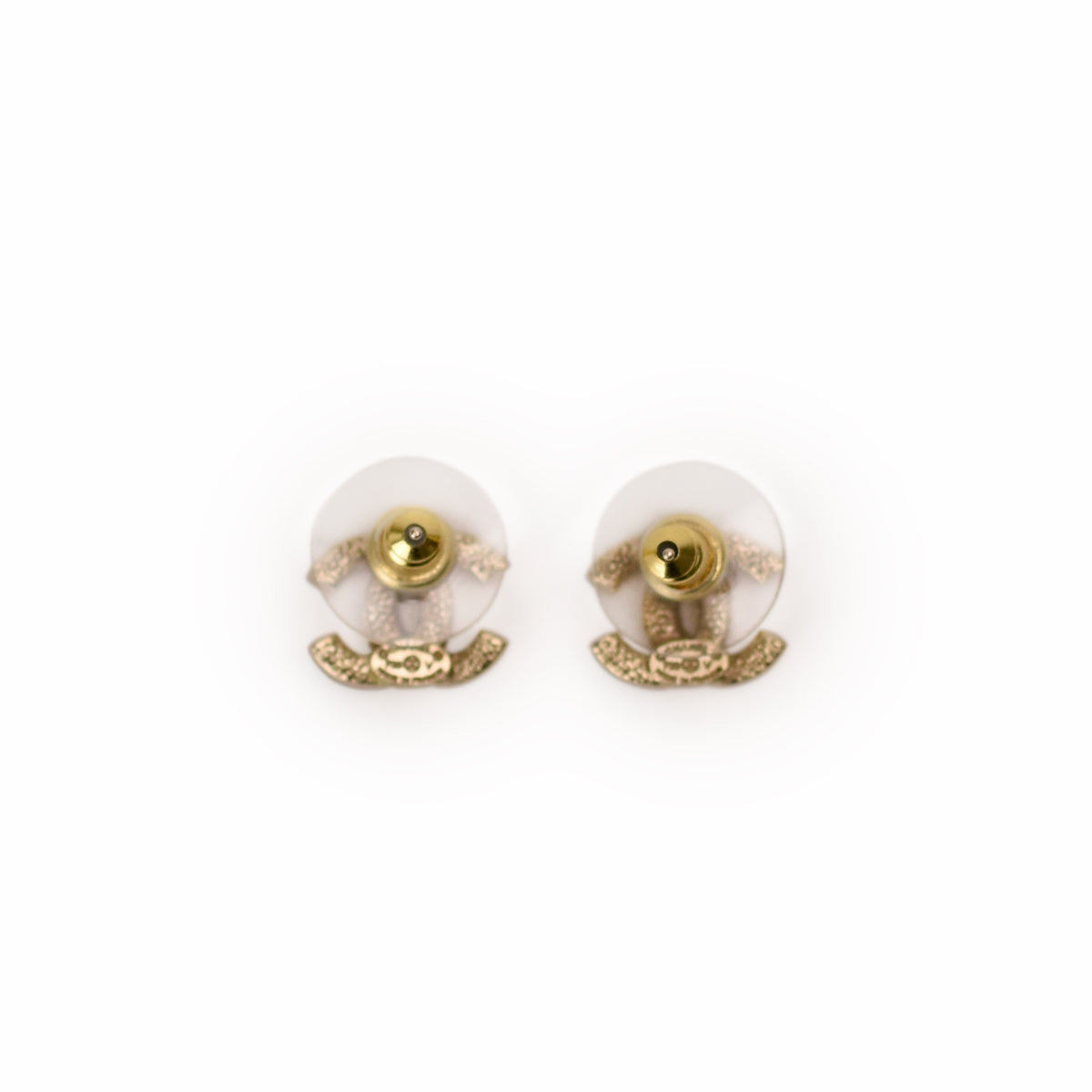 Gold-tone Chanel CC logo stud earrings with white enamel detail. curated Pre-loved Luxury by Myluxe in Helsinki.