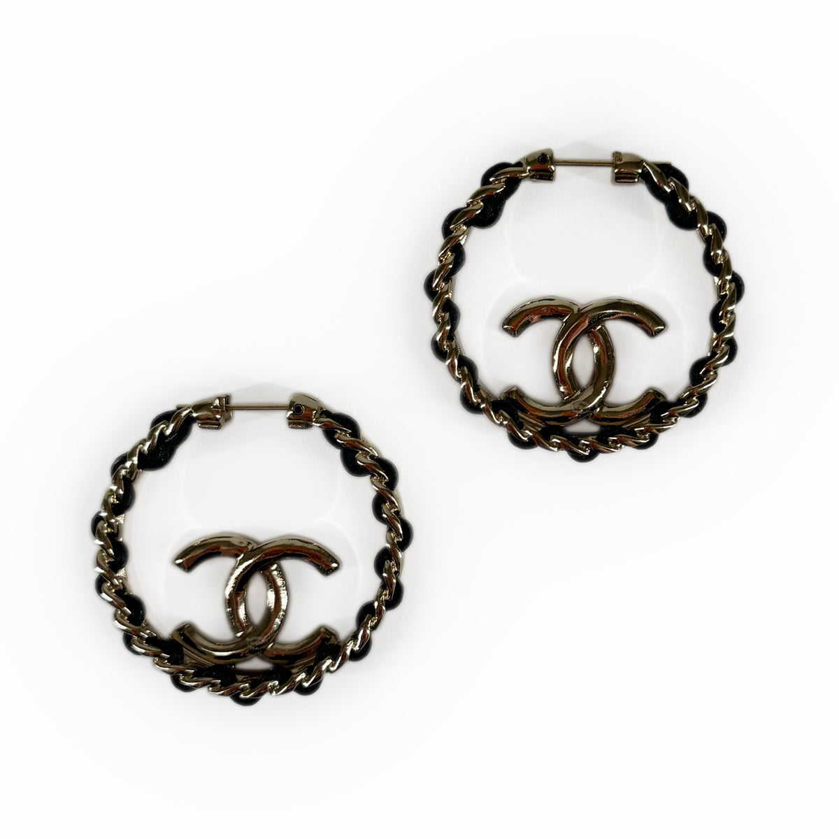 Gold-tone Chanel hoop earrings with black twisted metal accents, curated Pre-loved Luxury by Myluxe in Helsinki.