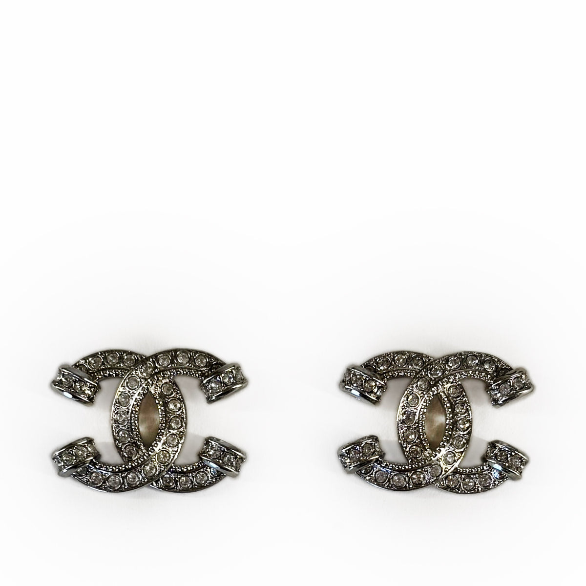 Silver-tone Chanel interlocking CC earrings encrusted with sparkling crystals, curated Pre-loved Luxury by Myluxe in Helsinki.