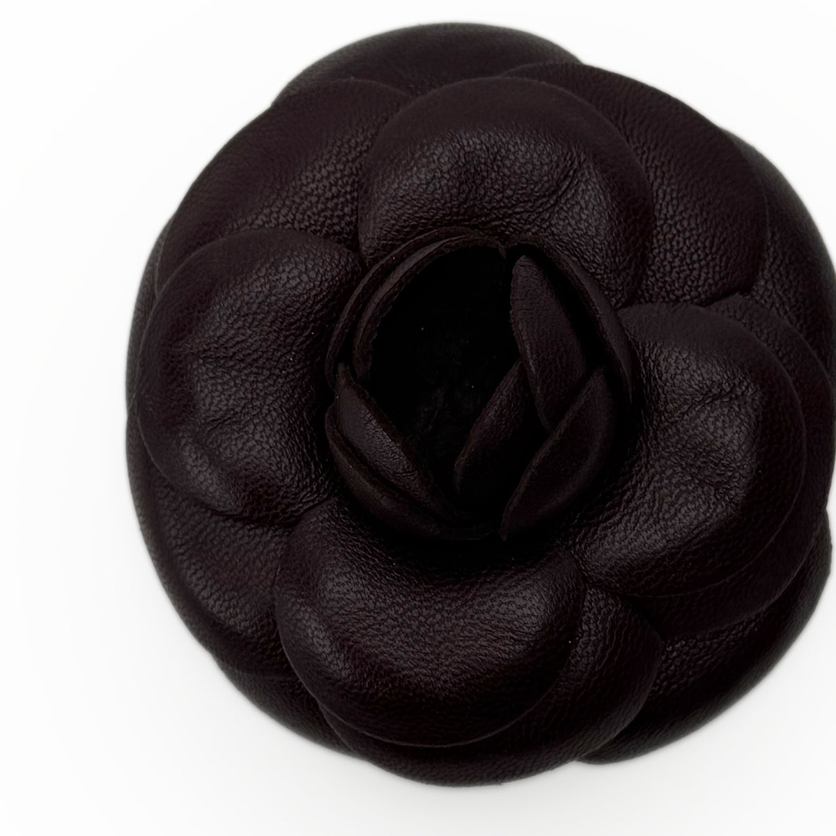 Black pebbled leather camellia flower accessory, curated Pre-loved Luxury by Myluxe in Helsinki.