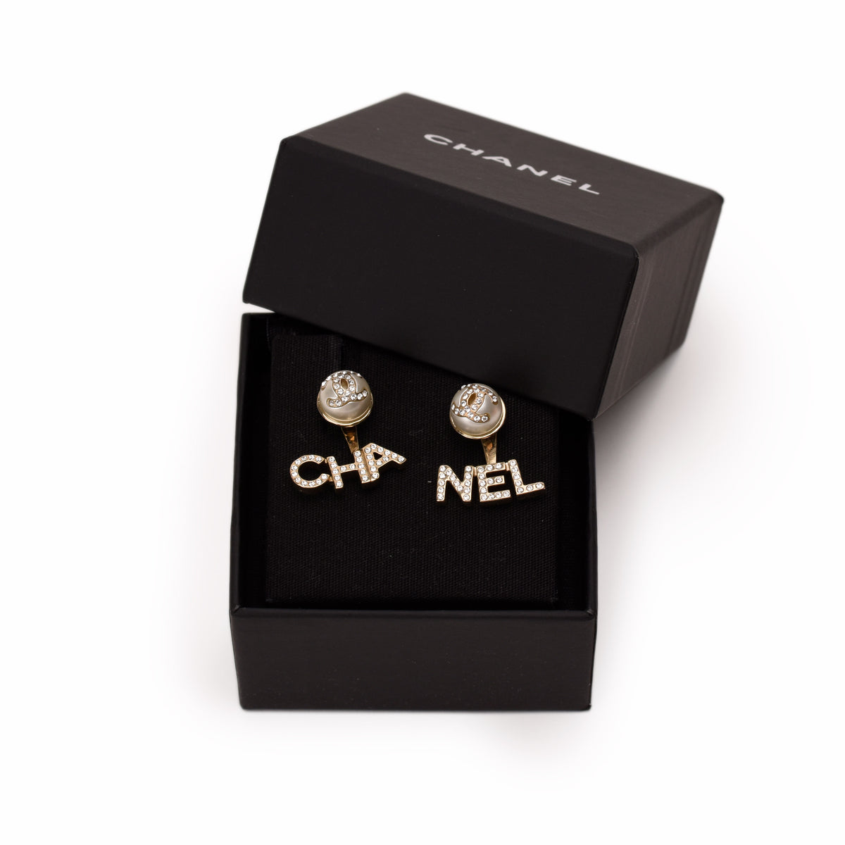Chanel gold-tone crystal-encrusted logo earrings in a black box. curated Pre-loved Luxury by Myluxe in Helsinki.