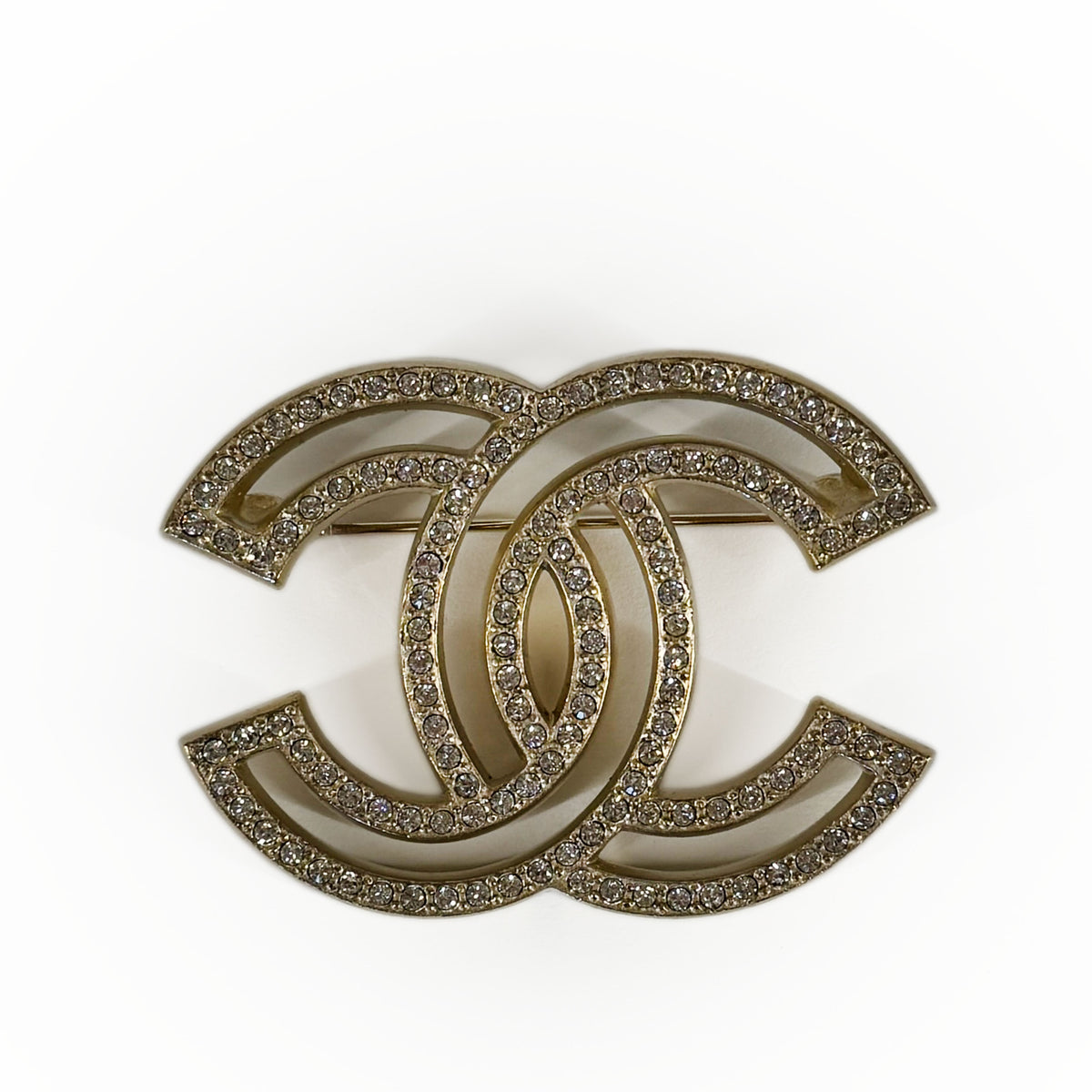 Gold-tone Chanel interlocking CC brooch encrusted with sparkling crystals, curated Pre-loved Luxury by Myluxe in Helsinki.