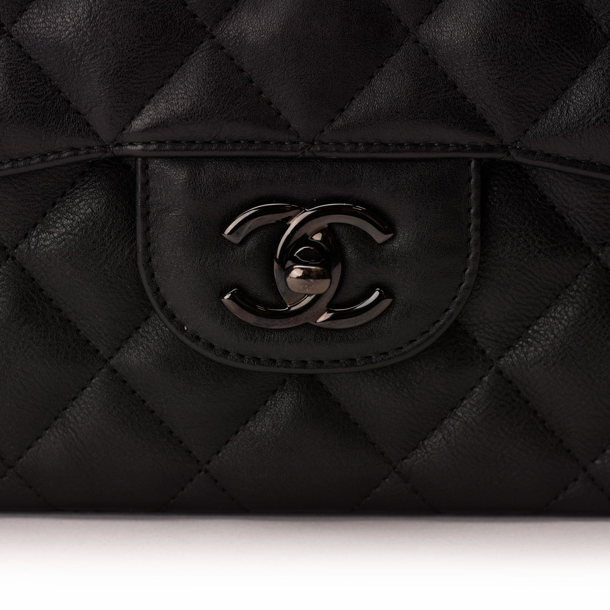 Black quilted leather Chanel handbag with signature interlocking CC logo. curated Pre-loved Luxury by Myluxe in Helsinki.