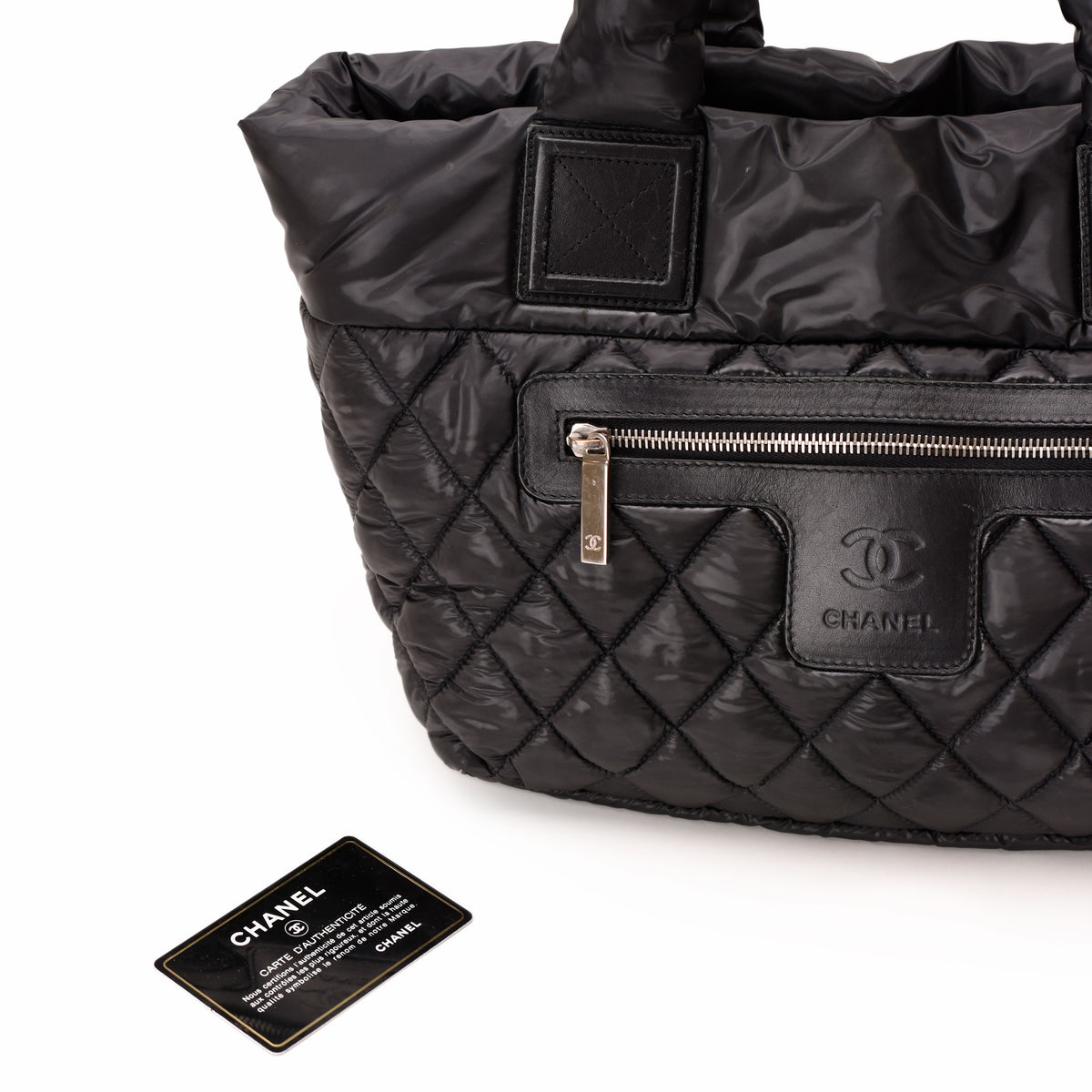 Black quilted nylon Chanel handbag with silver-tone hardware and authenticity card. curated Pre-loved Luxury by Myluxe in Helsinki.