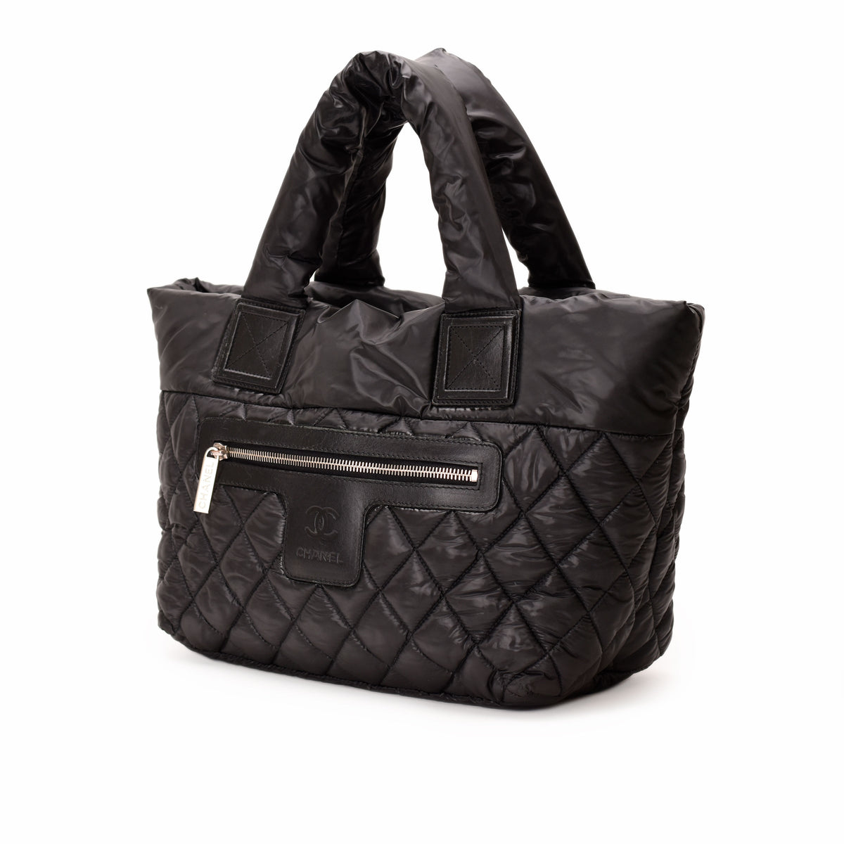 Black quilted nylon Chanel handbag with top handles and zipper pocket, curated Pre-loved Luxury by Myluxe in Helsinki.