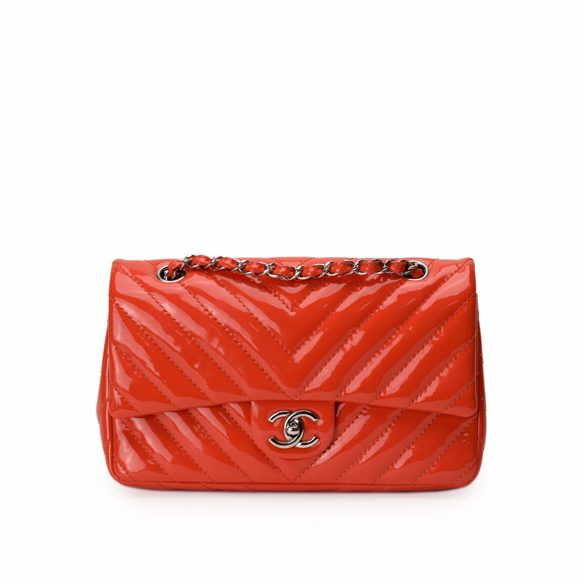 Red patent leather Chanel chevron quilted handbag with silver chain strap. curated Pre-loved Luxury by Myluxe in Helsinki.