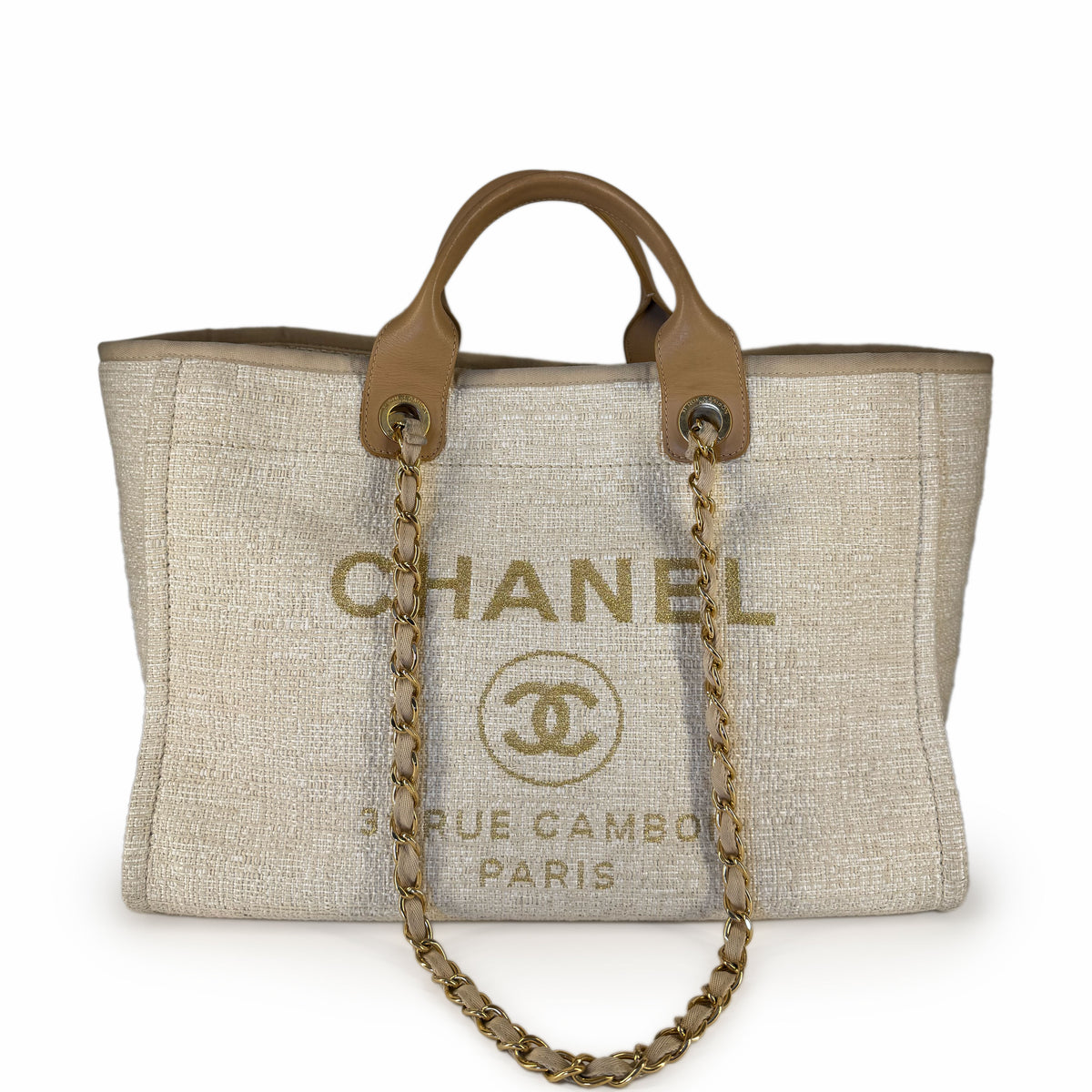 Chanel canvas tote bag in beige with tan leather handles and gold chain strap, curated Pre-loved Luxury by Myluxe in Helsinki.