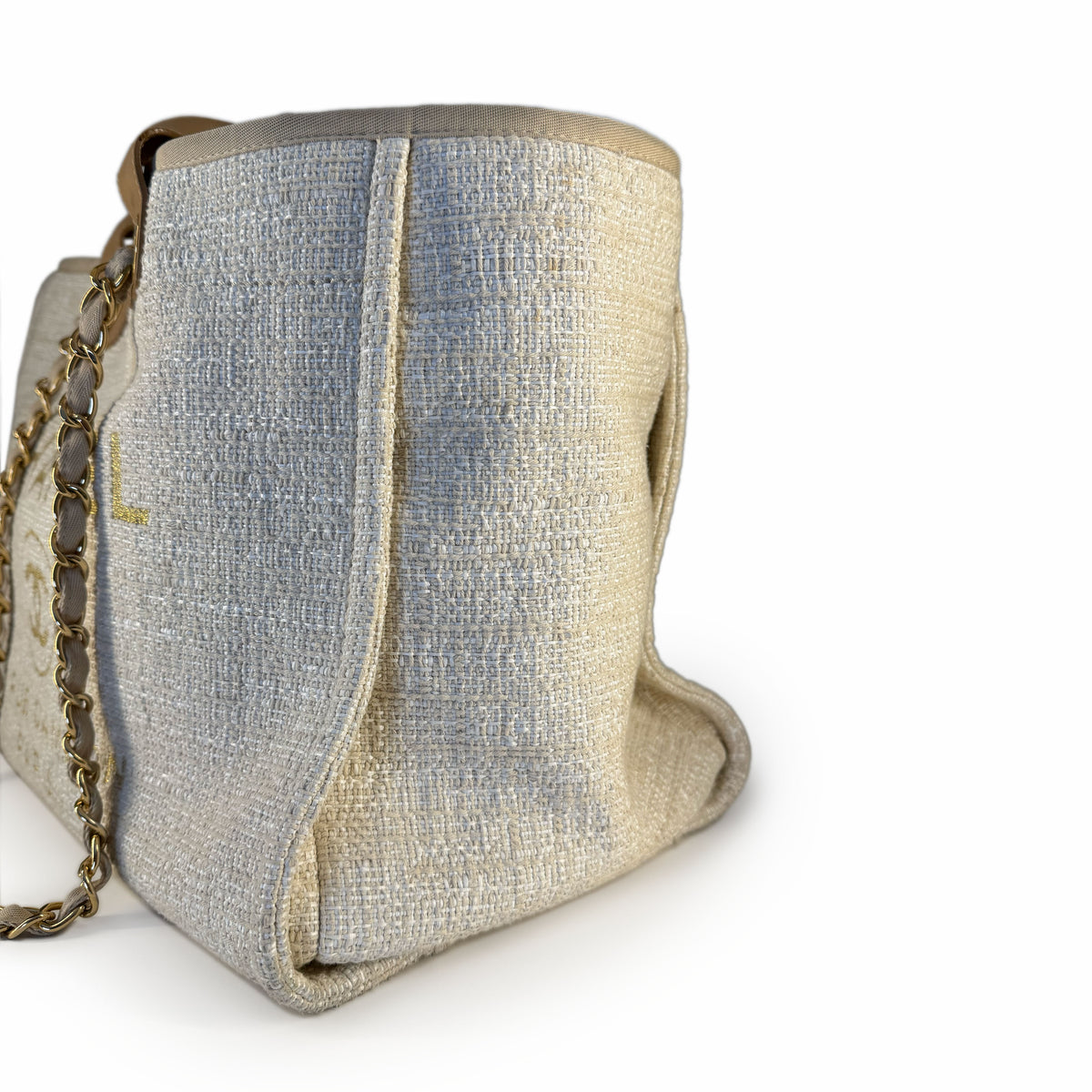 Beige textured canvas bucket bag with gold chain strap, curated Pre-loved Luxury by Myluxe in Helsinki.