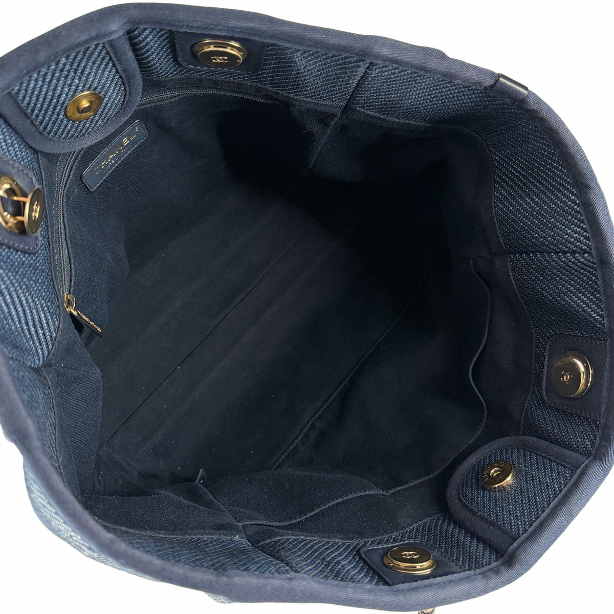 Interior of a navy blue Chanel canvas tote bag with gold-tone hardware, curated Pre-loved Luxury by Myluxe in Helsinki.