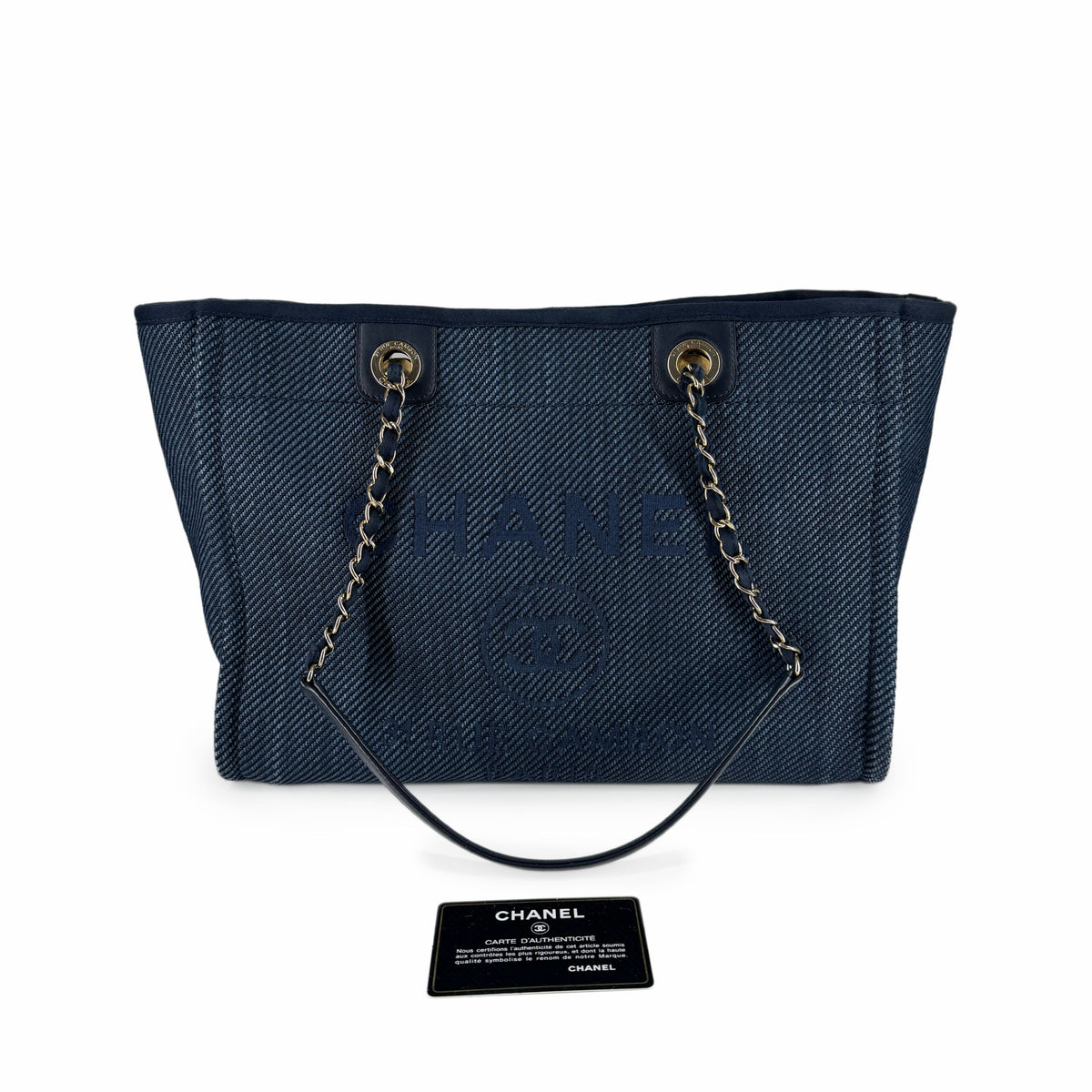 Navy blue Chanel canvas tote bag with silver chain straps, curated Pre-loved Luxury by Myluxe in Helsinki.