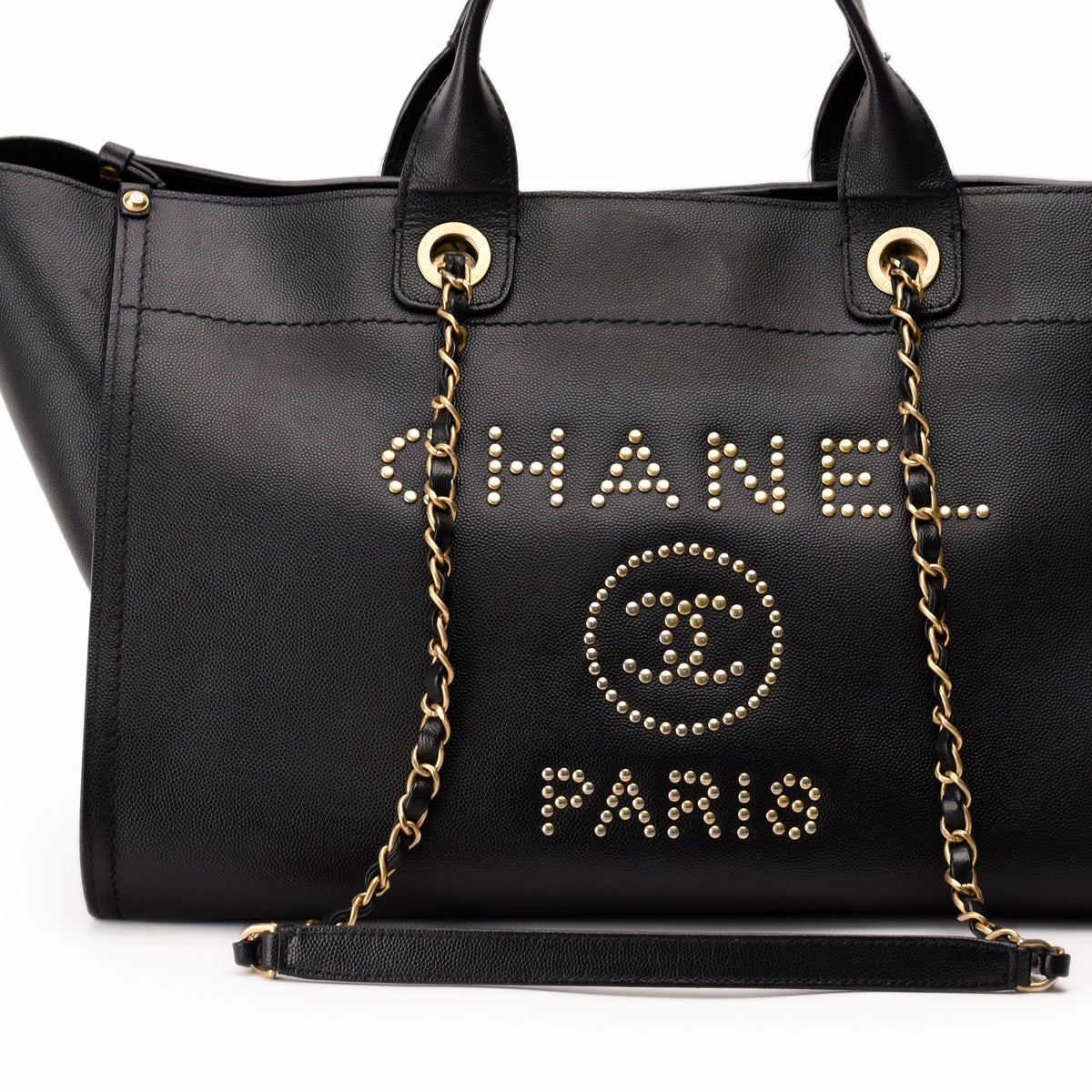 Black pebbled leather Chanel tote bag with gold-tone studded logo, curated Pre-loved Luxury by Myluxe in Helsinki.