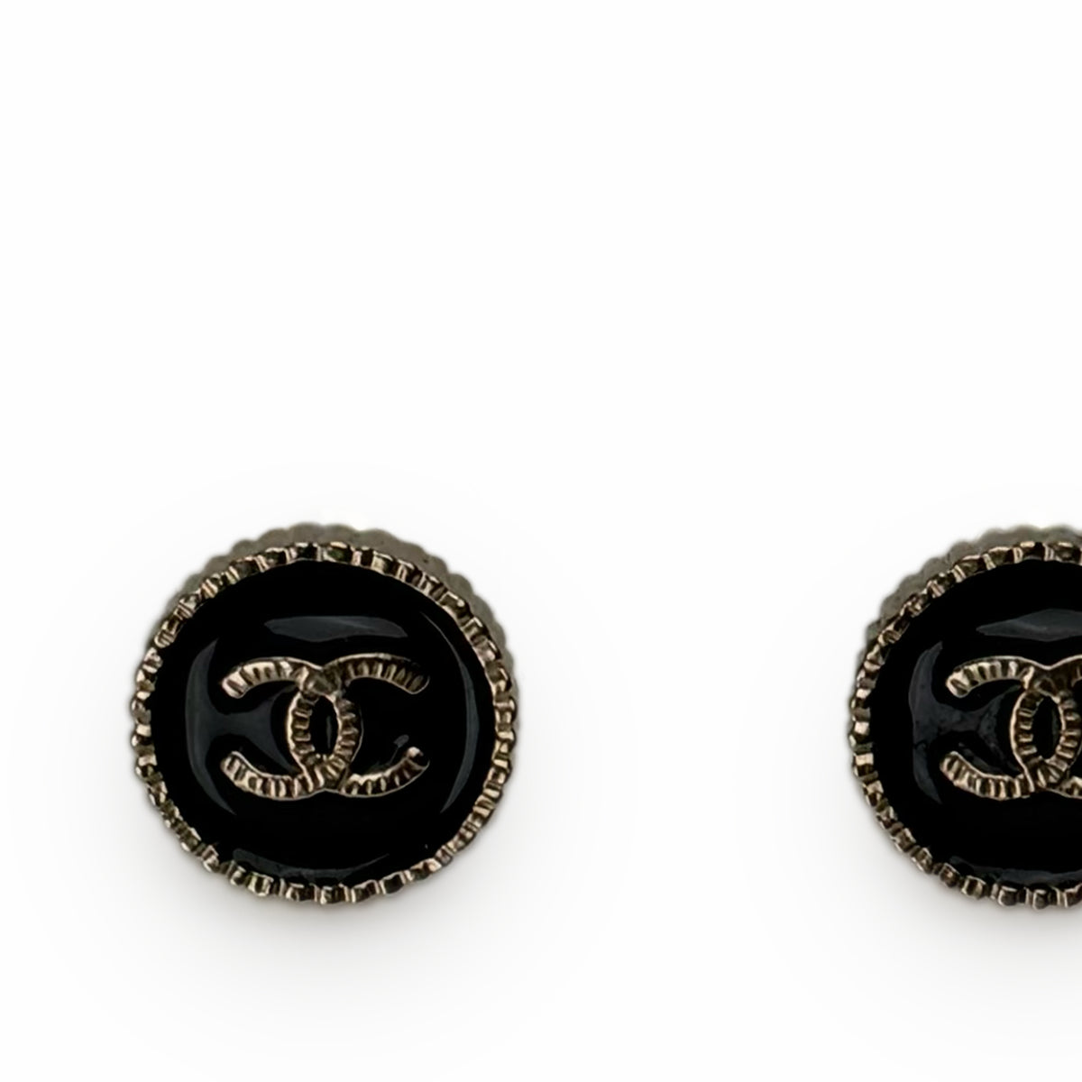 Chanel black enamel stud earrings with gold-tone interlocking CC logo, curated Pre-loved Luxury by Myluxe in Helsinki.