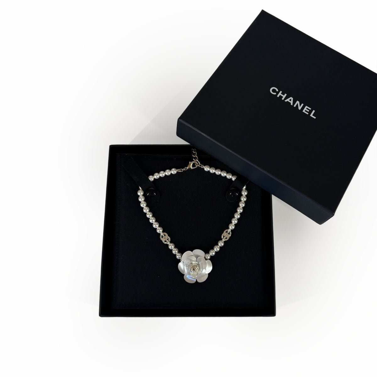 Chanel pearl necklace with a white mother of pearl flower charm, curated Pre-loved Luxury by Myluxe in Helsinki.