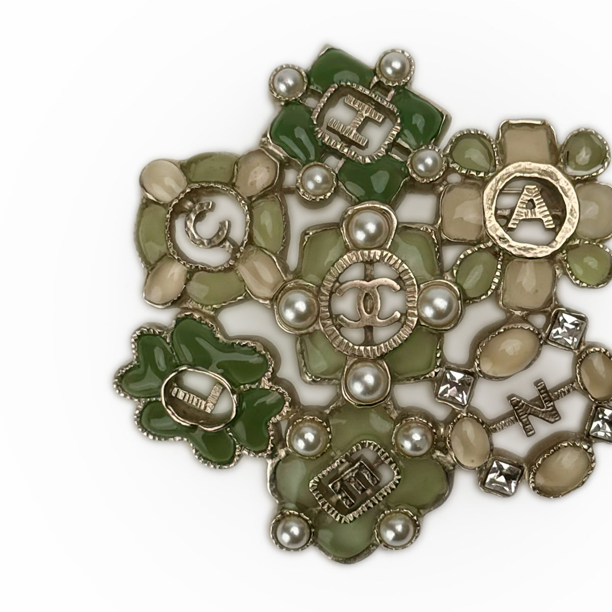 Gold-tone Chanel flower brooch with green and beige enamel, curated Pre-loved Luxury by Myluxe in Helsinki.