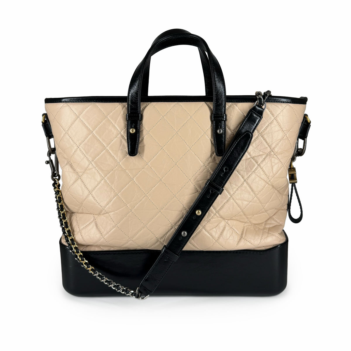 Beige quilted leather tote bag with black leather handles and crossbody strap, curated Pre-loved Luxury by Myluxe in Helsinki.