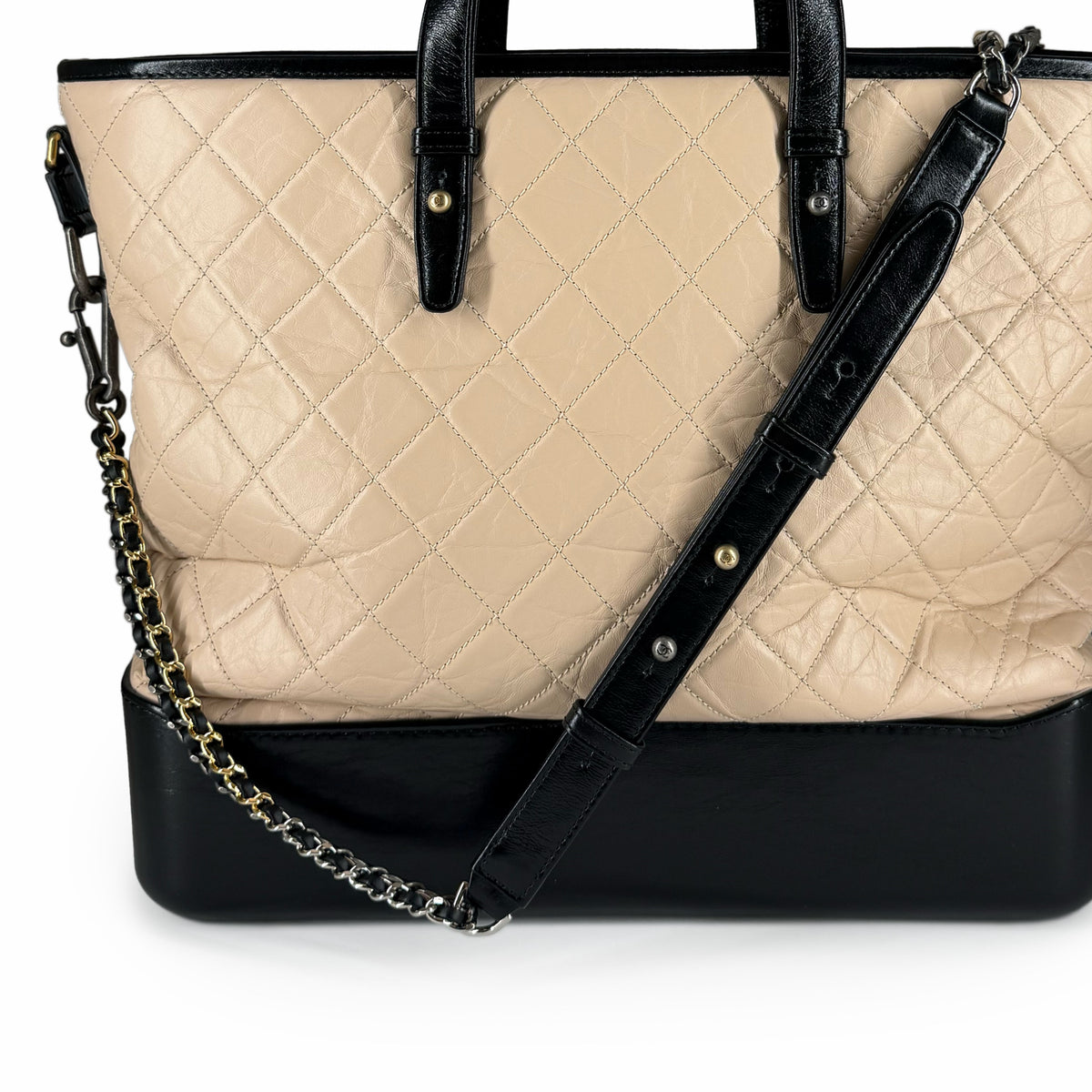 Beige quilted leather tote bag with black leather trim and chain strap, curated Pre-loved Luxury by Myluxe in Helsinki.
