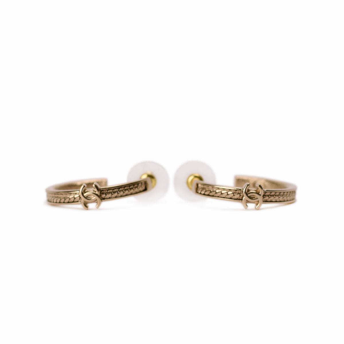 Gold-tone Chanel hoop earrings with interlocking CC logo detail. curated Pre-loved Luxury by Myluxe in Helsinki.