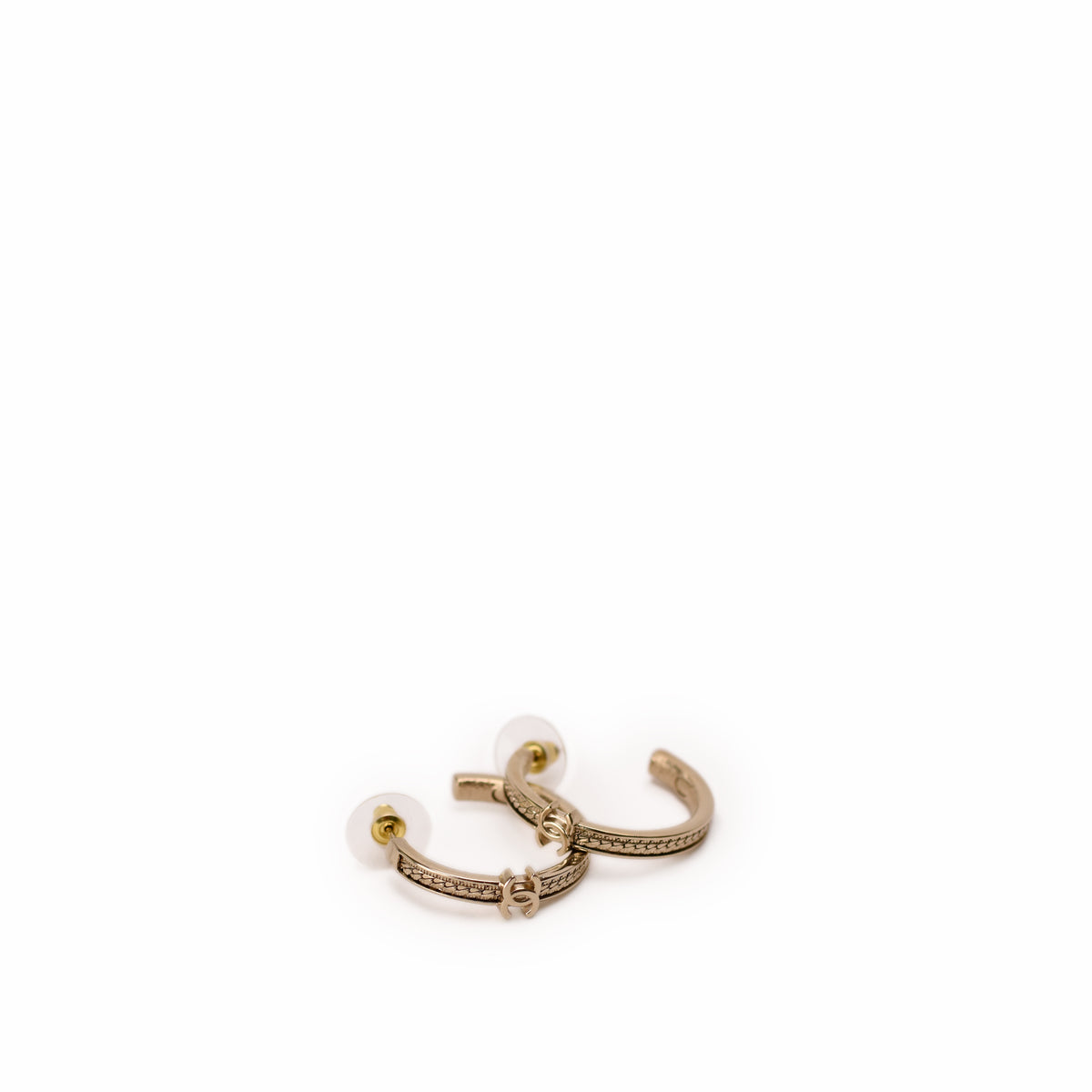 Chanel gold-tone hoop earrings with interlocking CC logo. curated Pre-loved Luxury by Myluxe in Helsinki.