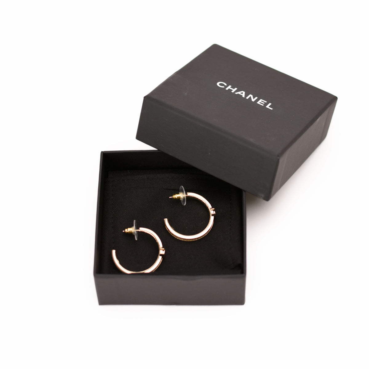 Gold-tone Chanel hoop earrings in a black designer box. curated Pre-loved Luxury by Myluxe in Helsinki.