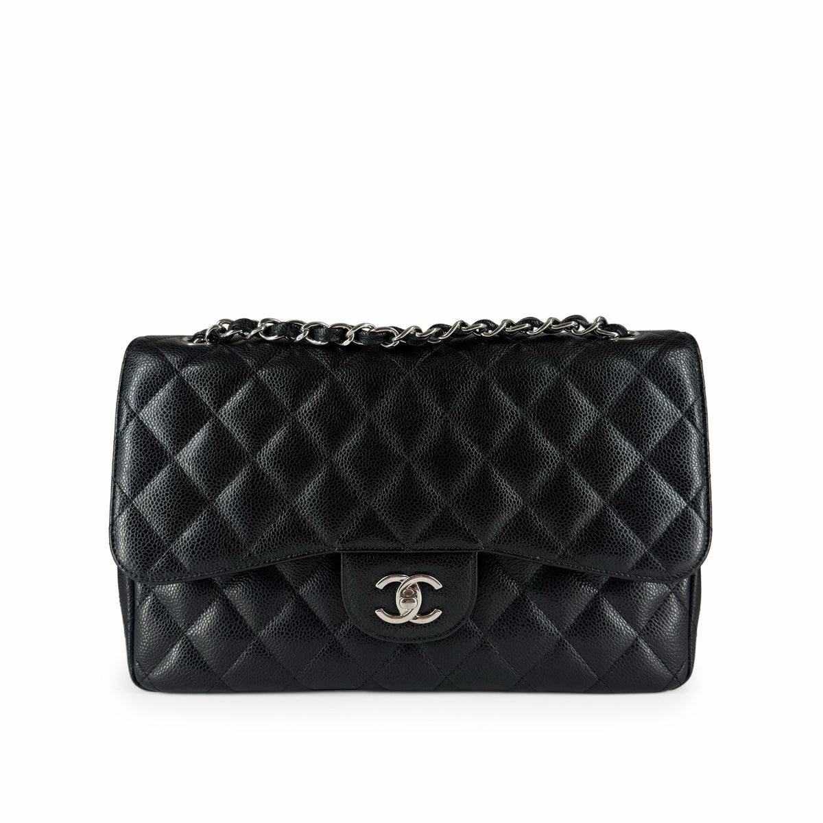 Black quilted leather Chanel flap bag with silver chain strap, curated Pre-loved Luxury by Myluxe in Helsinki.