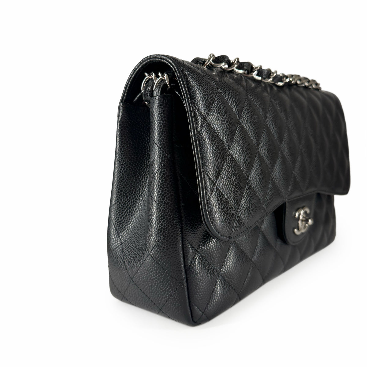 Black quilted leather Chanel flap handbag with silver chain strap, curated Pre-loved Luxury by Myluxe in Helsinki.
