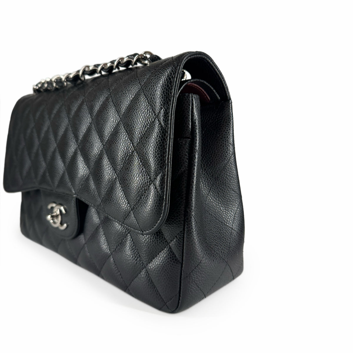 Black quilted leather Chanel flap handbag with silver chain strap, curated Pre-loved Luxury by Myluxe in Helsinki.
