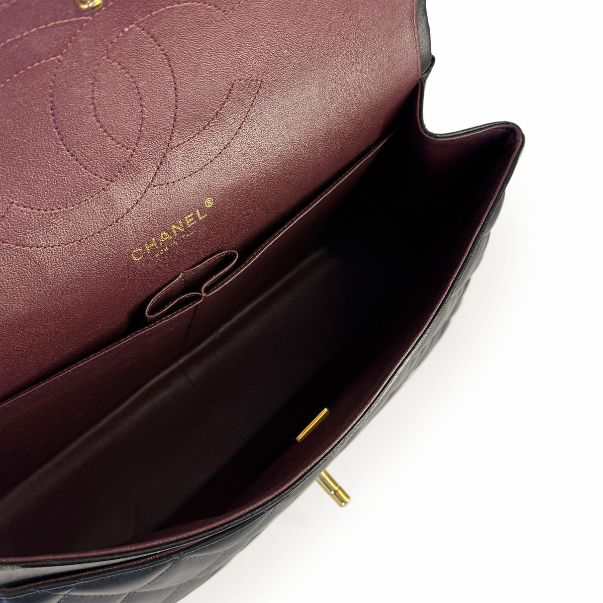 Interior of a burgundy quilted leather Chanel handbag, curated Pre-loved Luxury by Myluxe in Helsinki.