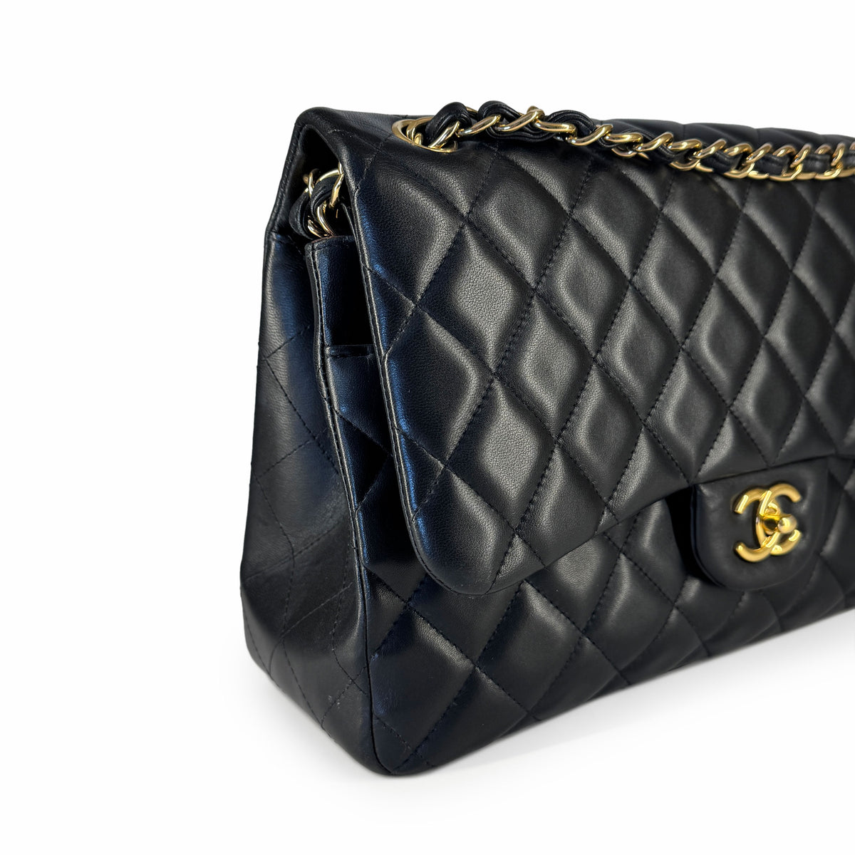 Black quilted leather Chanel flap bag with gold-tone chain strap, curated Pre-loved Luxury by Myluxe in Helsinki.