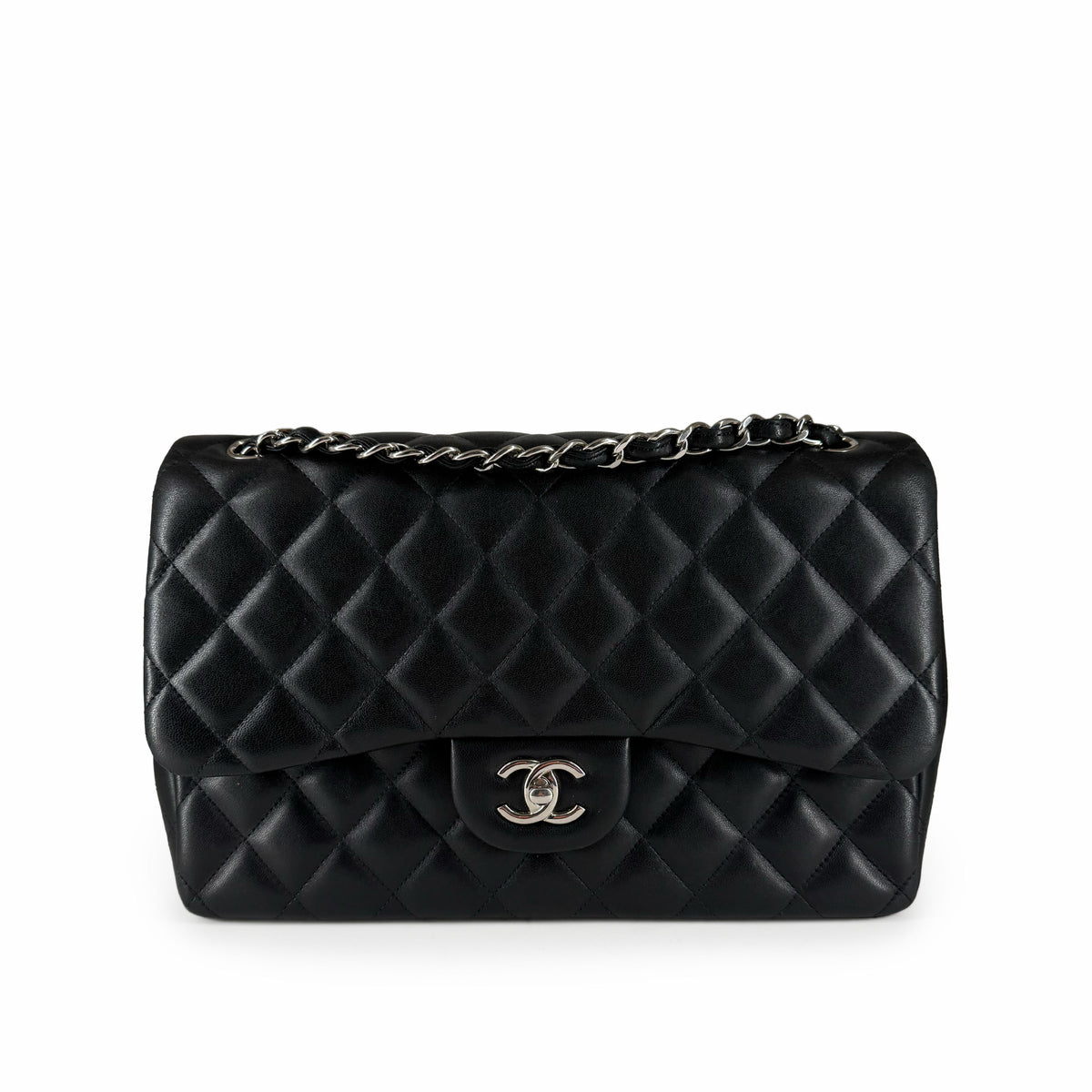 Black quilted leather Chanel handbag with silver chain strap, curated Pre-loved Luxury by Myluxe in Helsinki.