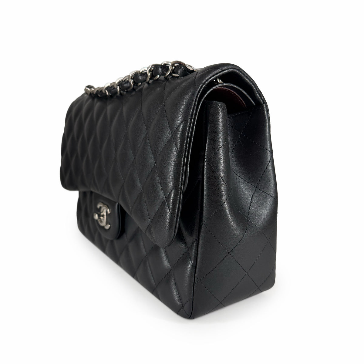 Black quilted lambskin Chanel flap bag with silver chain strap, curated Pre-loved Luxury by Myluxe in Helsinki.