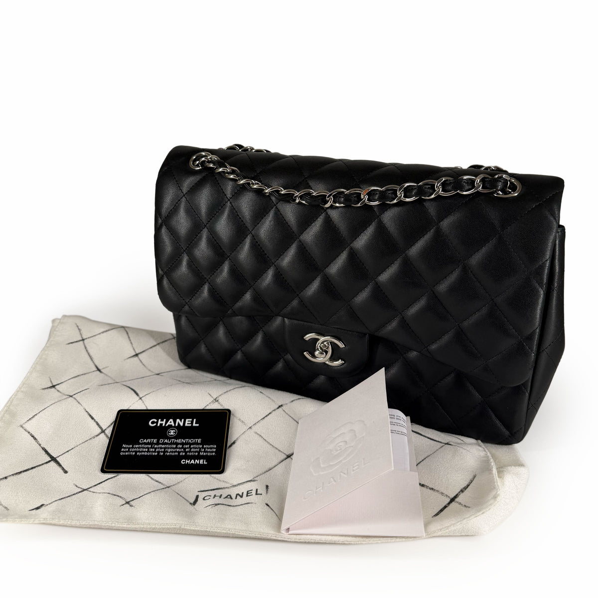Black quilted leather Chanel flap bag with silver chain strap, curated Pre-loved Luxury by Myluxe in Helsinki.